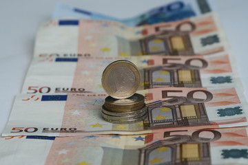 euro coins on top of euro banknotes