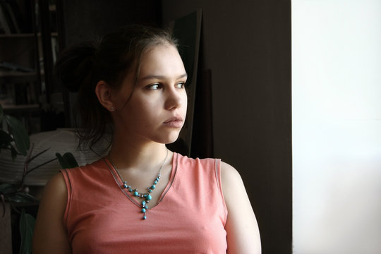 Unhappy Teen By The Window