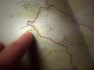 Fototapeta na wymiar finger pointing at map
