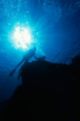 sun burst and scuba divers