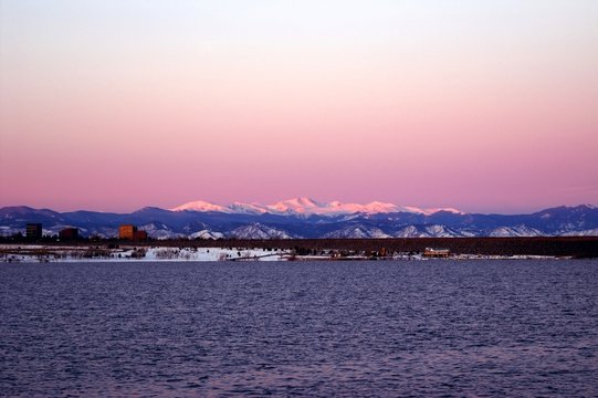 Winter Sunrise In Denver With A Lake And Mountains