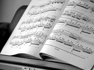 Naklejka premium classical music notation book on a piano