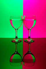 two glasses on neon background