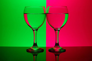 two glasses on neon background