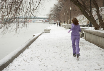 woman jogging at river embankment