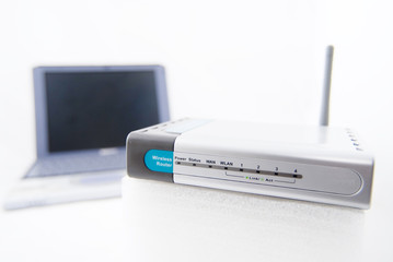 silver laptop and wireless router