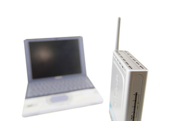silver laptop and wireless router