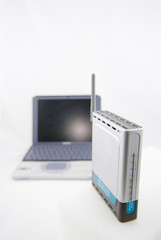 silver laptop and wireless router