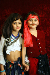 the boy and the girl in suits (pirate and gipsy).