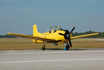 Fototapeta premium vintage yellow airplane on the ground
