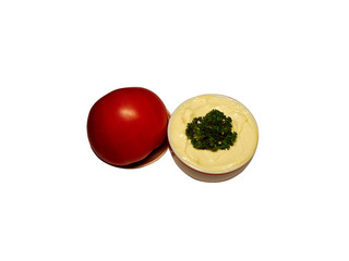 mayonnaise in sauce-boat with tomato on saucer