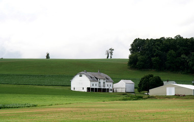 farm house with barn on hill