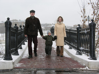 family on winter bridge