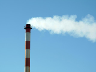 chimney in factory expelling smoke in the atmosphere