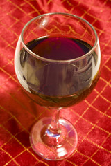 wine glass on red christmas tablecloth