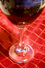 wine glass on red christmas tablecloth