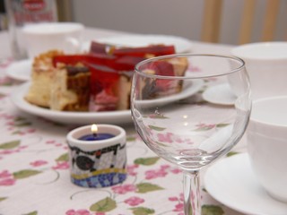 cake, glass nad candle on the table