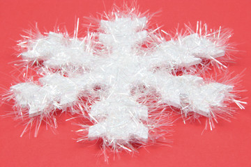 white snowflake on red background