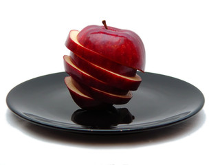 sliced apple on black plate too