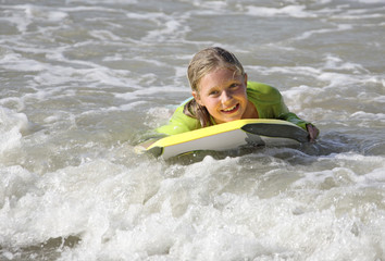girl surfing on a boogie board