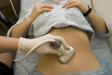 scanning of a stomach of the woman.