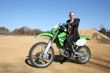 Fototapeta na wymiar businessman on dirt bike