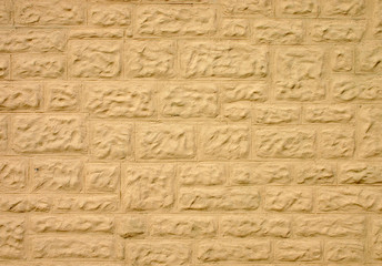 stone wall covered in cream colored coating