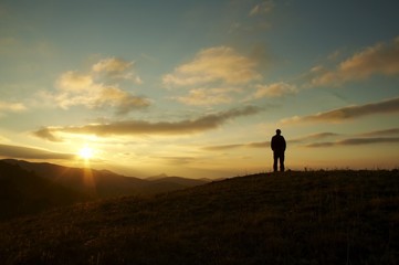 men silhouette on the sunset