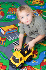 little boy playing with his toy.
