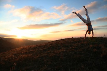 sunset and acrobatic girl