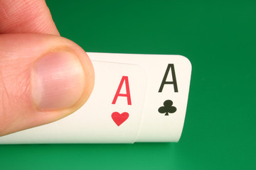 looking at pocket aces during a poker game.