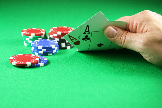 poker - a pair of aces with poker chips