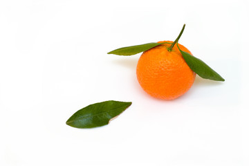 a tangerine with a green leaf