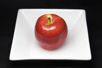 red apple on white plate