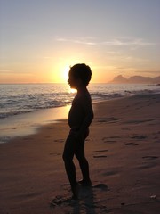 kid on the beach in silhouette