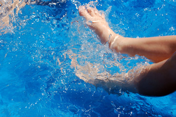 boy kicking in pool