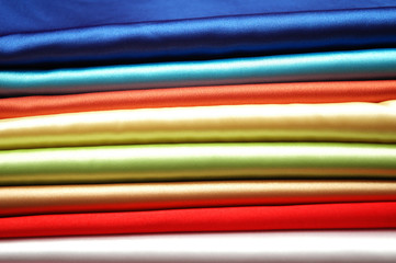 stack of satin fabric of various colours