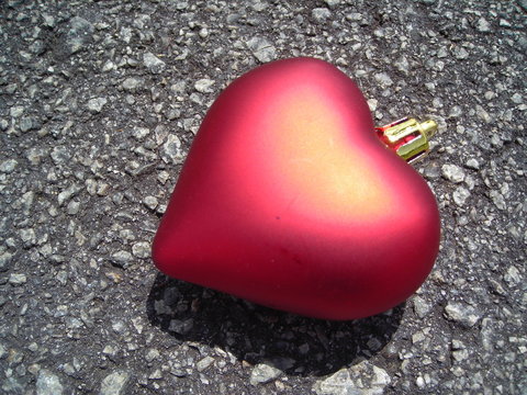 single red heart against bituman background