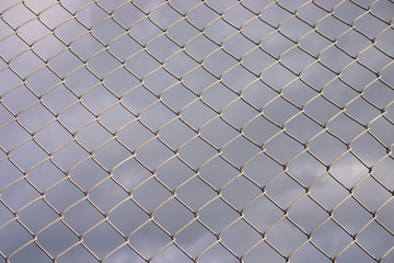 Fototapeta premium metal security fence with a dark cloudy background