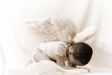 little boy as angel in sepia
