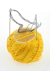 yellow thread and needles on white