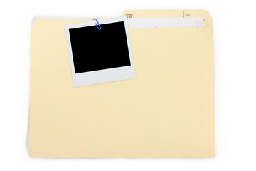 a polaroid photo and file folder
