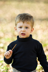 a little boy eating short stick