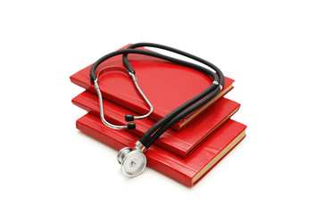 stack of study books and stethoscope isolated on w