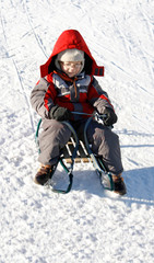 Fototapeta na wymiar boy on sled in winter time