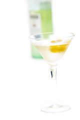 glass with martini and olives and bottle