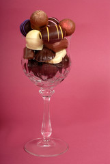 delicious dark and semi-sweet chocolates in a cut crystal wine g