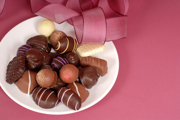 plate of delicious dark and semi-sweet chocolates with pink ribb