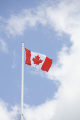 canadian flag in front of clouds
