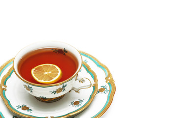 tea with lemon and saucers isolated on the white